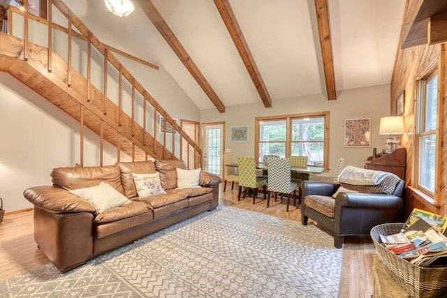 living room with hardwood / wood-style flooring, beam ceiling, and high vaulted ceiling