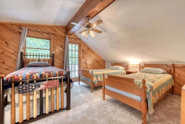 bedroom featuring ceiling fan, carpet floors, wooden walls, and lofted ceiling with beams