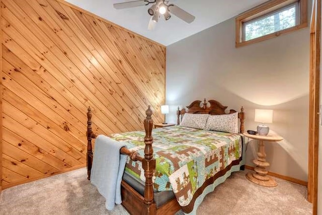 bedroom with ceiling fan, carpet floors, lofted ceiling, and wood walls