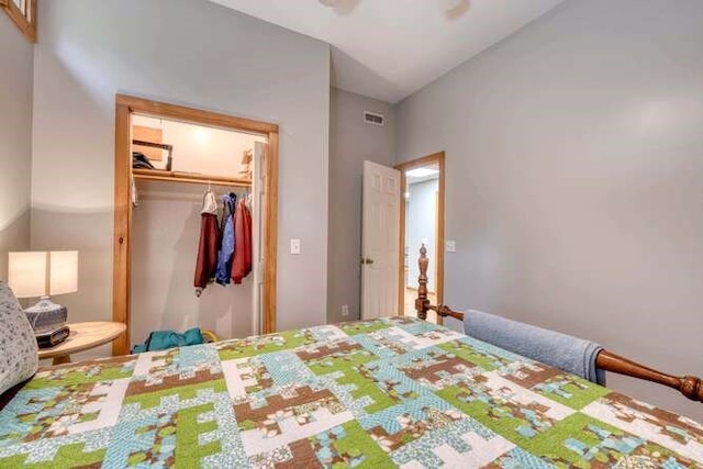 bedroom featuring ceiling fan, a closet, and lofted ceiling