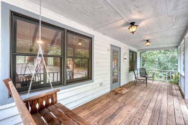 wooden terrace featuring covered porch