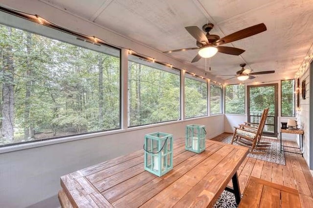 unfurnished sunroom featuring ceiling fan