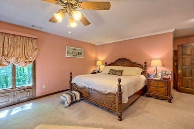 bedroom with light colored carpet and ceiling fan