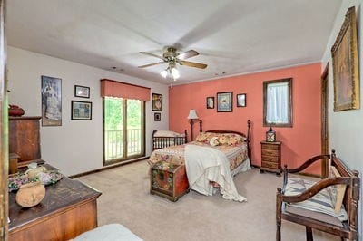 carpeted bedroom featuring access to outside and ceiling fan