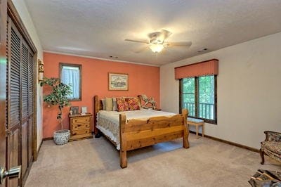 bedroom with light colored carpet, ceiling fan, and ornamental molding