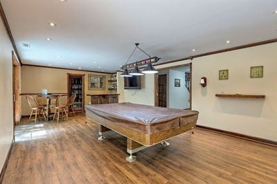 recreation room with hardwood / wood-style flooring, ornamental molding, and pool table