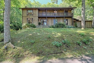 rear view of property with a lawn