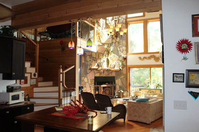 601 Sierra Cir, Murphy, NC 28906 - living room with stairs, a chandelier, wood finished floors, and a stone fireplace