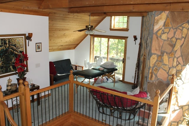 living area with wood ceiling, lofted ceiling with beams, hardwood / wood-style flooring, and ceiling fan