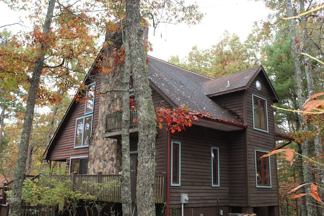 view of side of home with a balcony