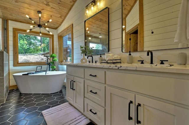 bathroom featuring lofted ceiling, wood ceiling, an inviting chandelier, vanity, and a tub to relax in