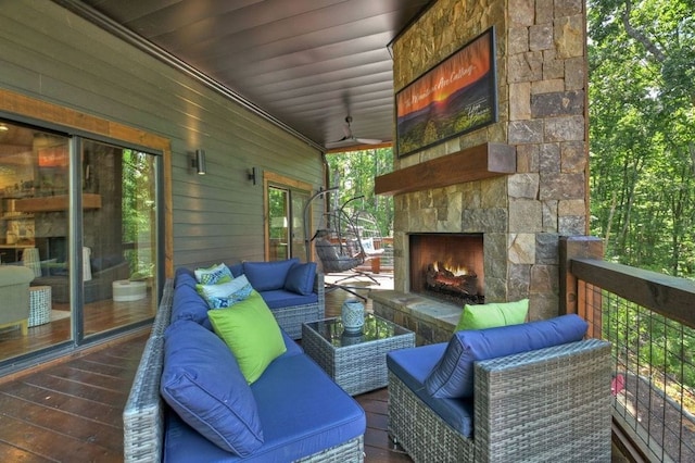 wooden terrace with an outdoor living space with a fireplace