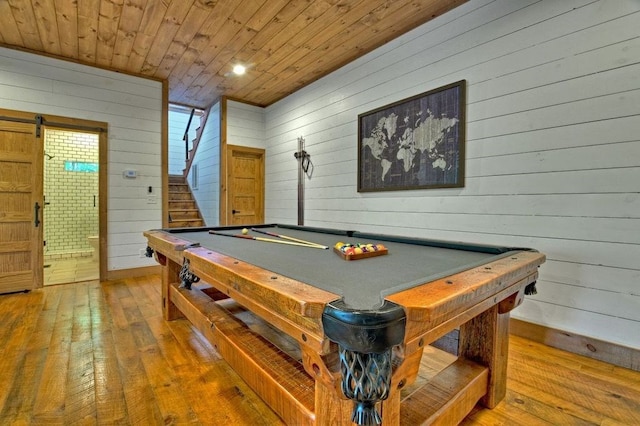 recreation room with wood ceiling, wood-type flooring, and wood walls