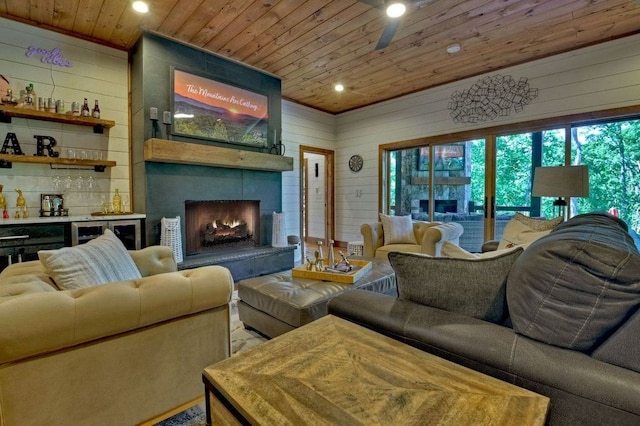 living room featuring indoor bar, wooden ceiling, and wood walls