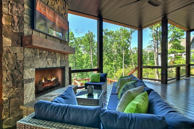 sunroom with an outdoor stone fireplace