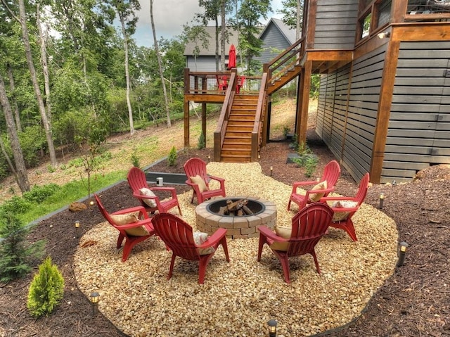 exterior space featuring a wooden deck and a fire pit