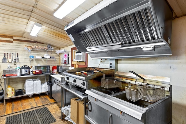 kitchen with premium range hood, vaulted ceiling, light wood-type flooring, and wood walls