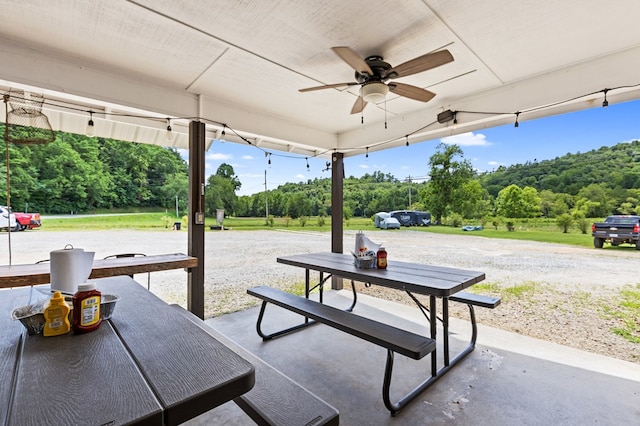 exterior space with ceiling fan