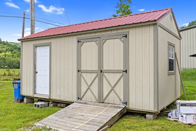 view of outbuilding featuring a yard