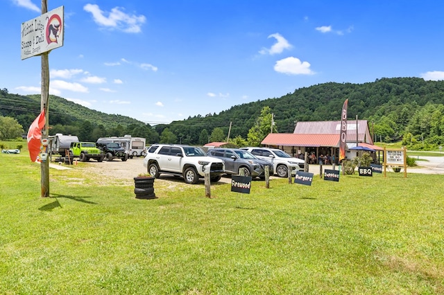 exterior space with a mountain view and a yard