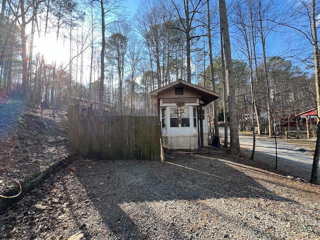 view of outdoor structure with an outbuilding and fence