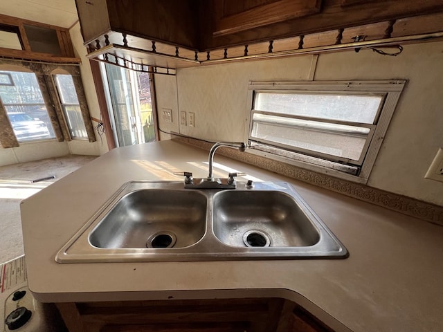 kitchen featuring light countertops and a sink