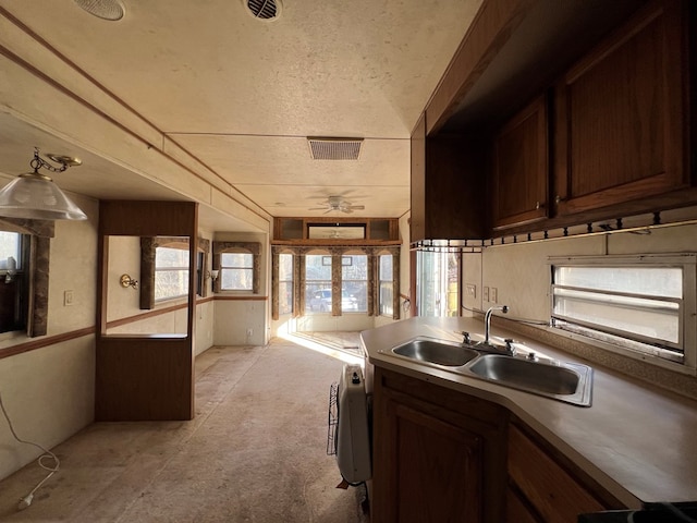 kitchen featuring ceiling fan, dishwashing machine, visible vents, and a sink