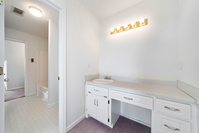 full bathroom with a washtub, visible vents, vanity, and a textured ceiling