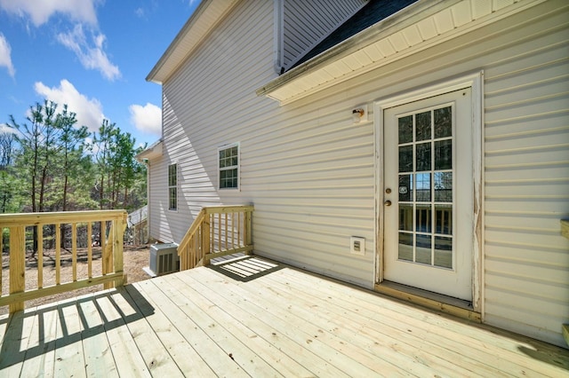 wooden deck featuring cooling unit