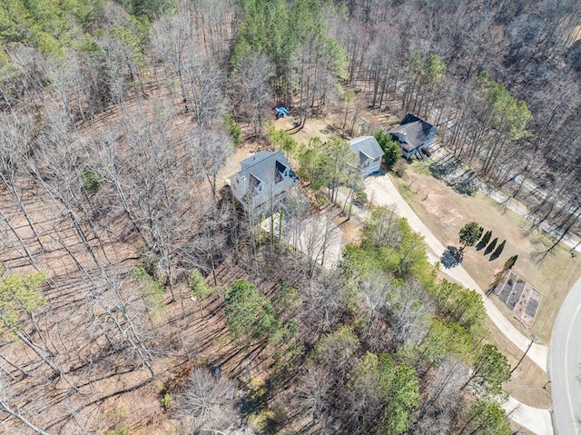 drone / aerial view featuring a wooded view