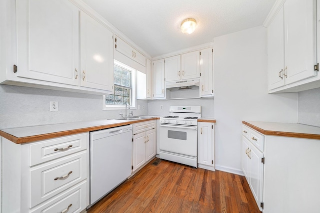 kitchen with white appliances, white cabinets, a sink, and under cabinet range hood