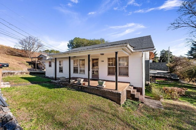 bungalow with covered porch and a front lawn