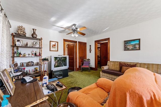 living room with a textured ceiling, carpet floors, and ceiling fan