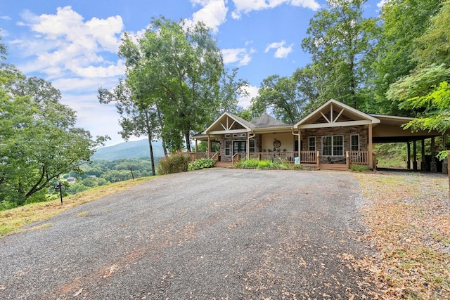 view of front of house featuring a carport and a porch