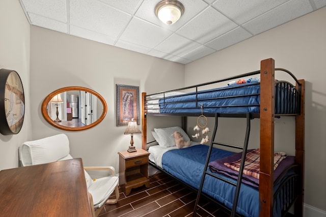 bedroom featuring a paneled ceiling and tile patterned flooring