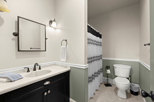 bathroom featuring toilet, tile patterned floors, and vanity