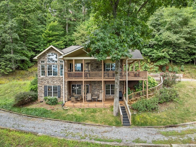 back of property with a patio and a deck