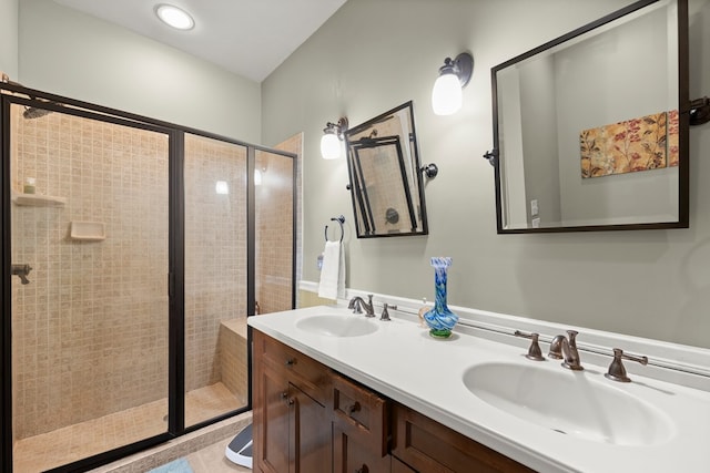 bathroom with double sink vanity and a shower with door