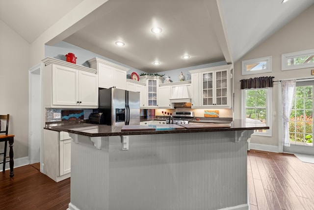 kitchen featuring stainless steel fridge with ice dispenser, dark hardwood / wood-style flooring, white cabinetry, and tasteful backsplash