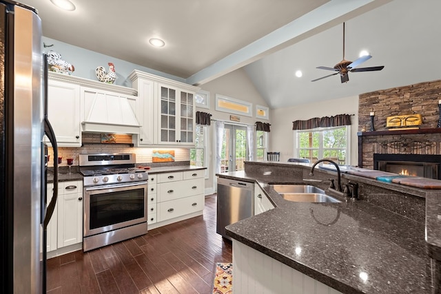 kitchen with appliances with stainless steel finishes, sink, custom exhaust hood, and white cabinets