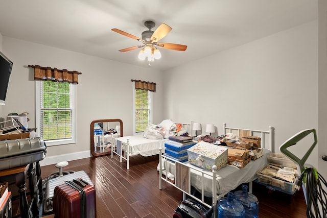 bedroom with ceiling fan and dark hardwood / wood-style floors