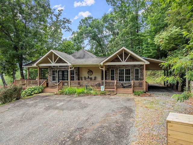 view of front of home with covered porch and a carport