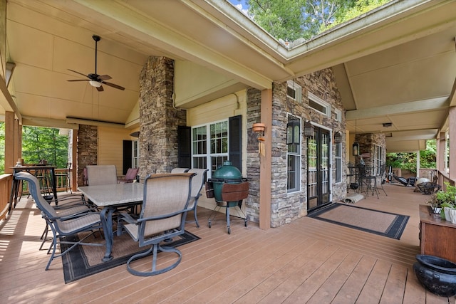 wooden deck with ceiling fan and french doors