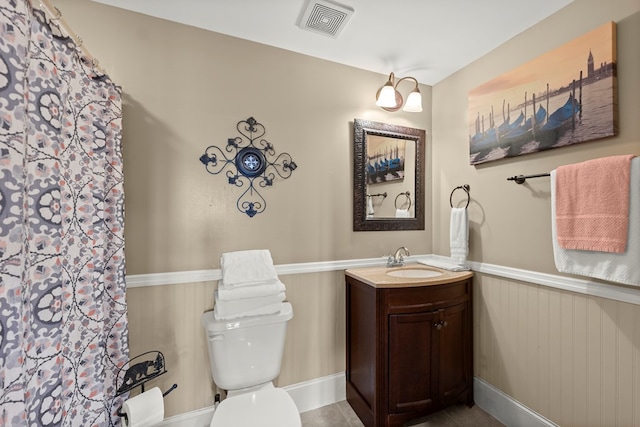 bathroom featuring tile patterned floors, vanity, and toilet