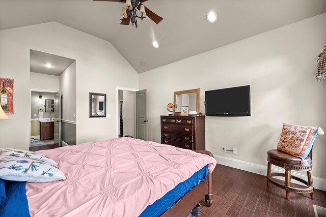 bedroom with ceiling fan, dark hardwood / wood-style floors, vaulted ceiling, and ensuite bath