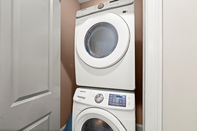 laundry area with stacked washing maching and dryer