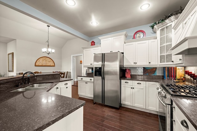 kitchen with lofted ceiling with beams, appliances with stainless steel finishes, sink, and tasteful backsplash