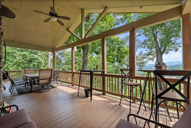 wooden deck featuring ceiling fan