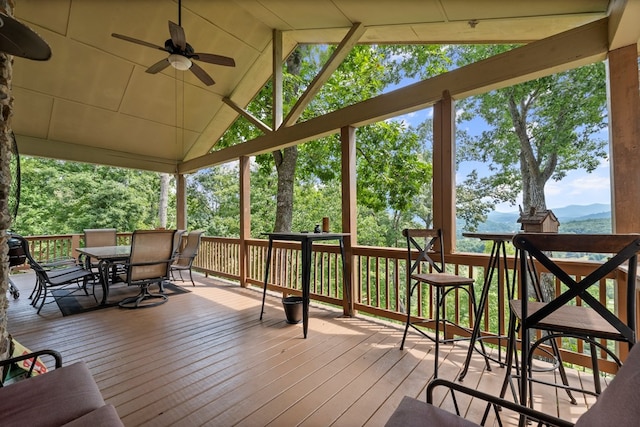 wooden deck featuring a mountain view and ceiling fan