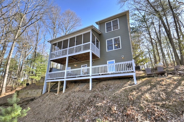 rear view of property with a sunroom